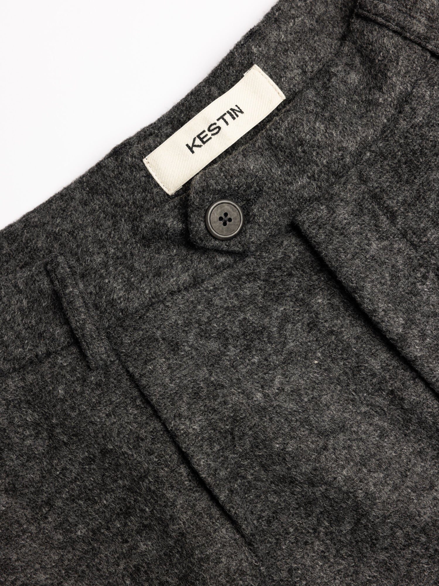 Close-up of Trouser fixed waistband with single front button and branded label