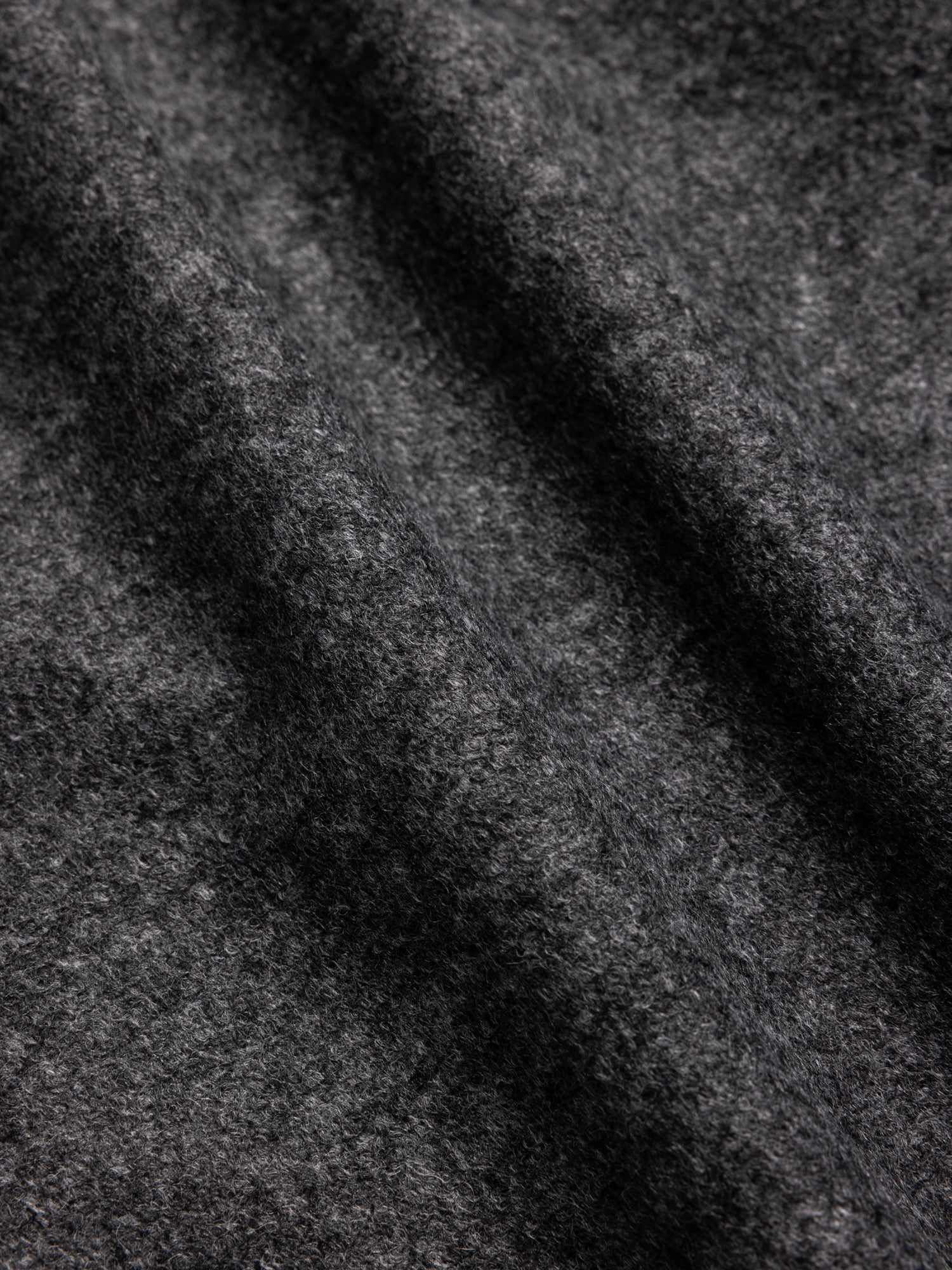 Closeup detail of a charcoal wool blend fabric