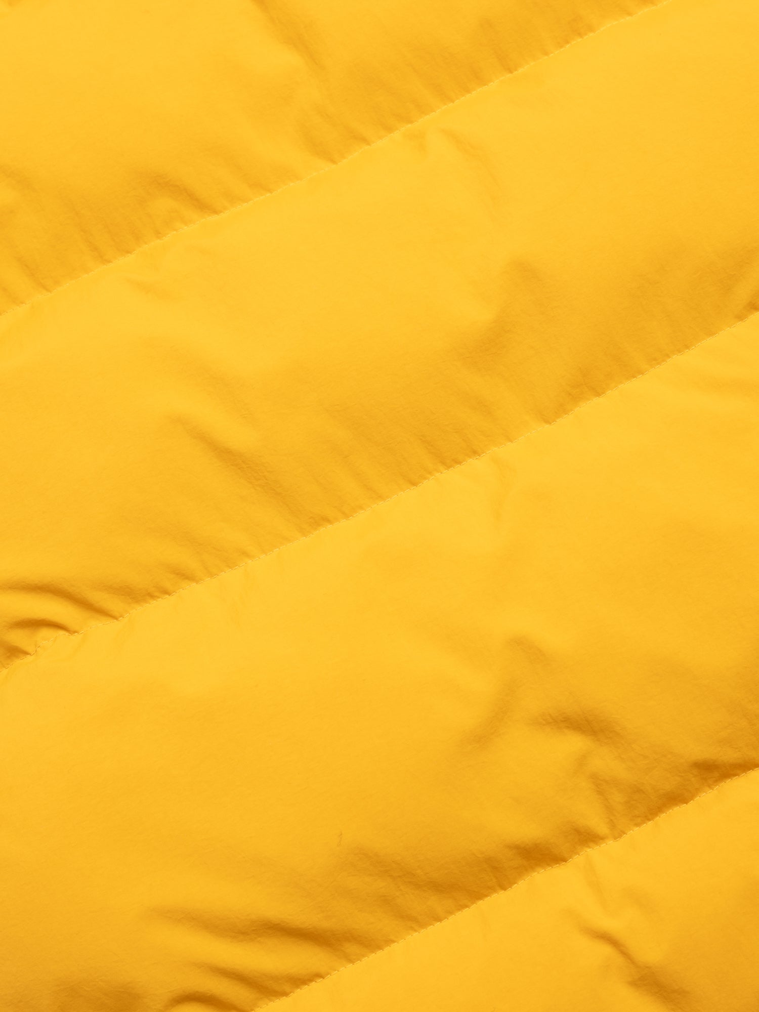 Close-up of a yellow quilted fabric texture