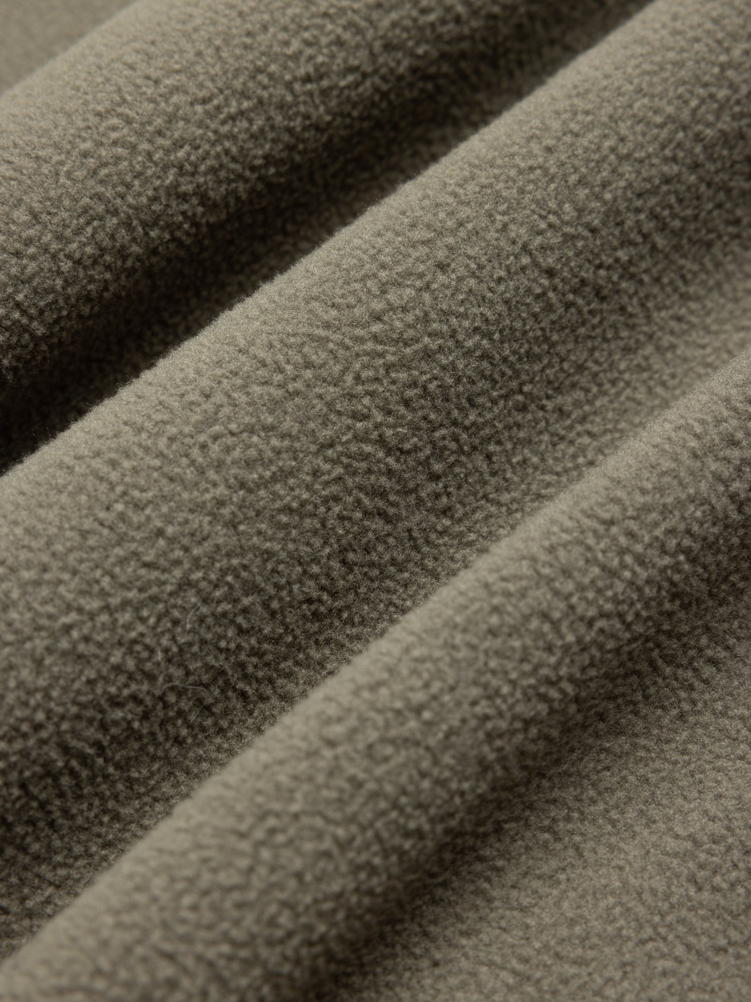 Close-up of textured green fleece fabric