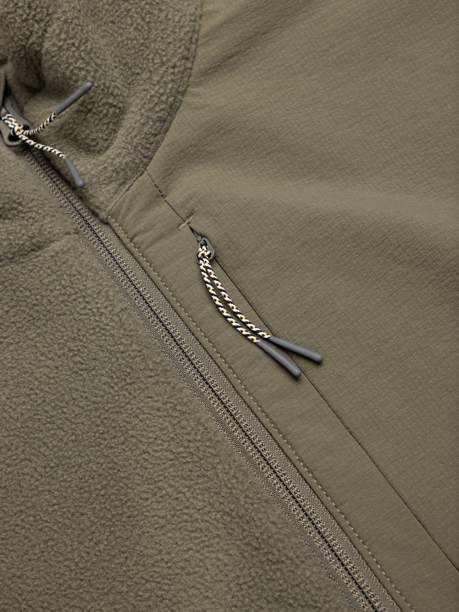 Close-up of a green fleece with a zippered chest pocket