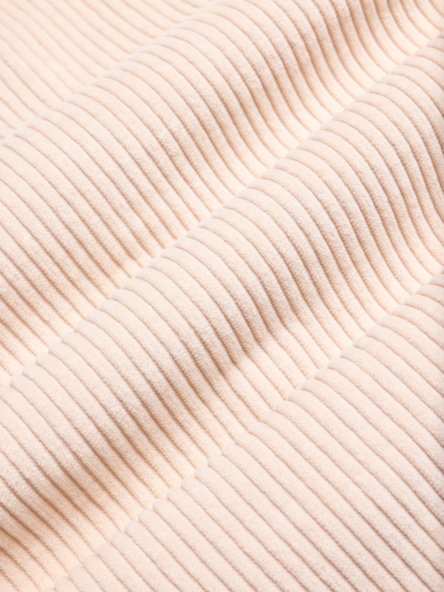 Close-up of beige textured corduroy fabric