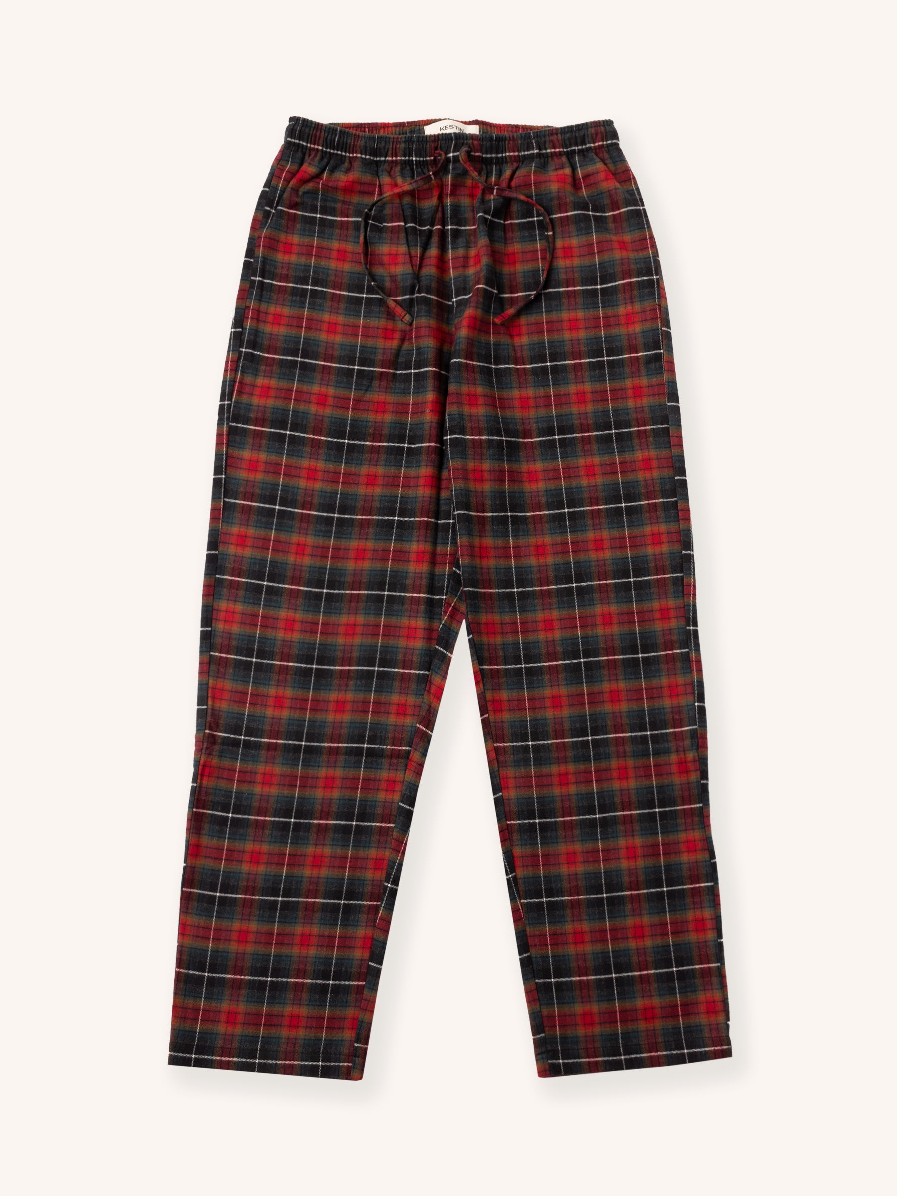 Red and navy tartan plaid pyjama pants on a white background