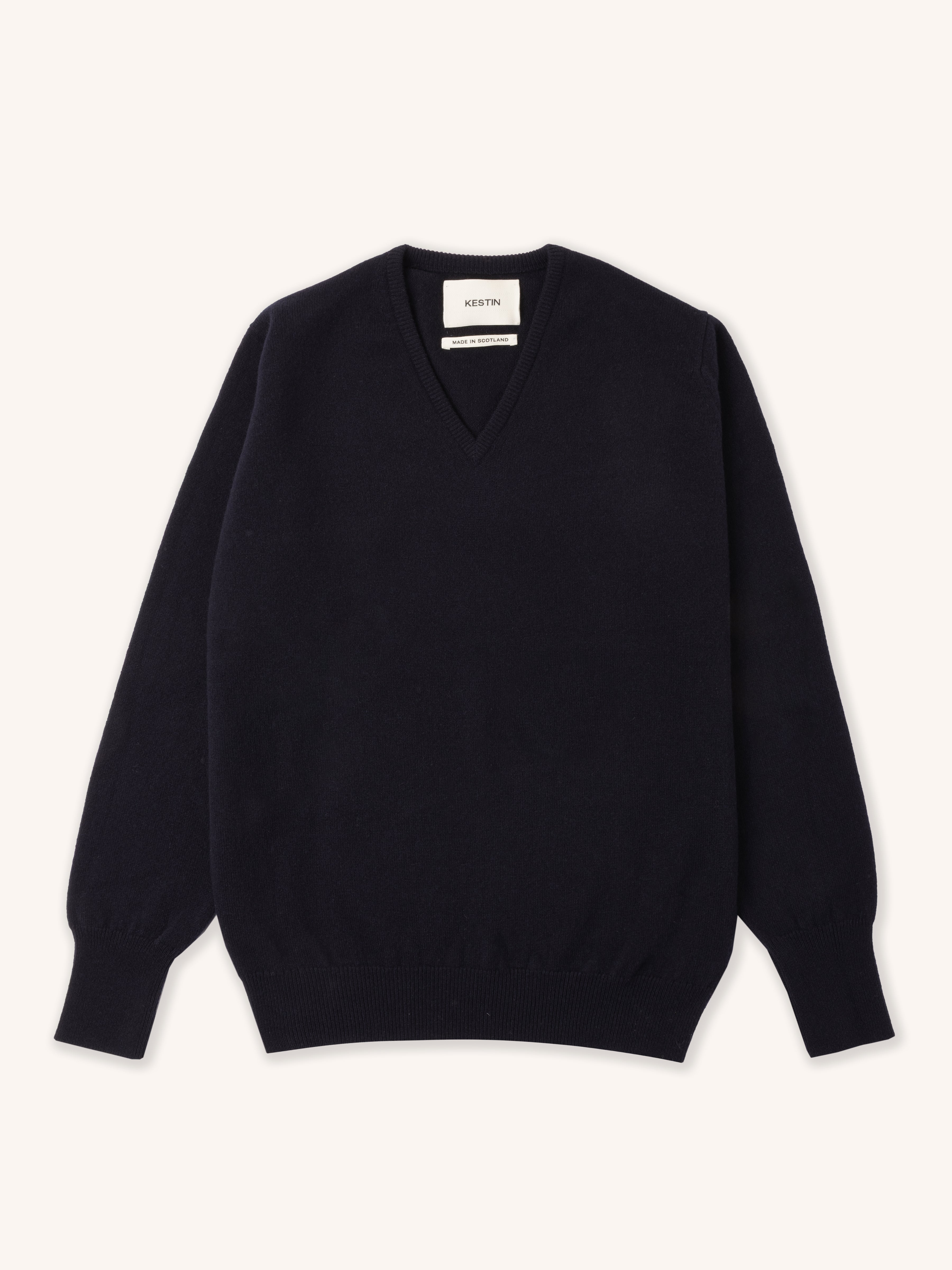 Dark navy blue v-neck sweater on a white background