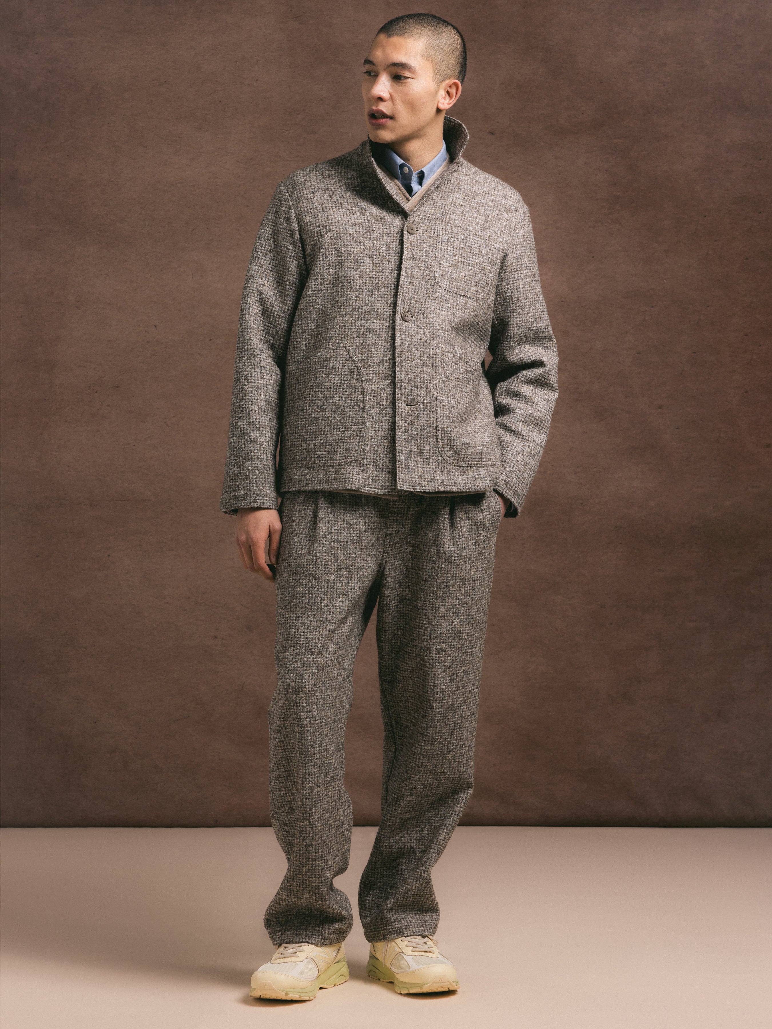 A man wearing a premium wool blend two piece suit in a taupe check