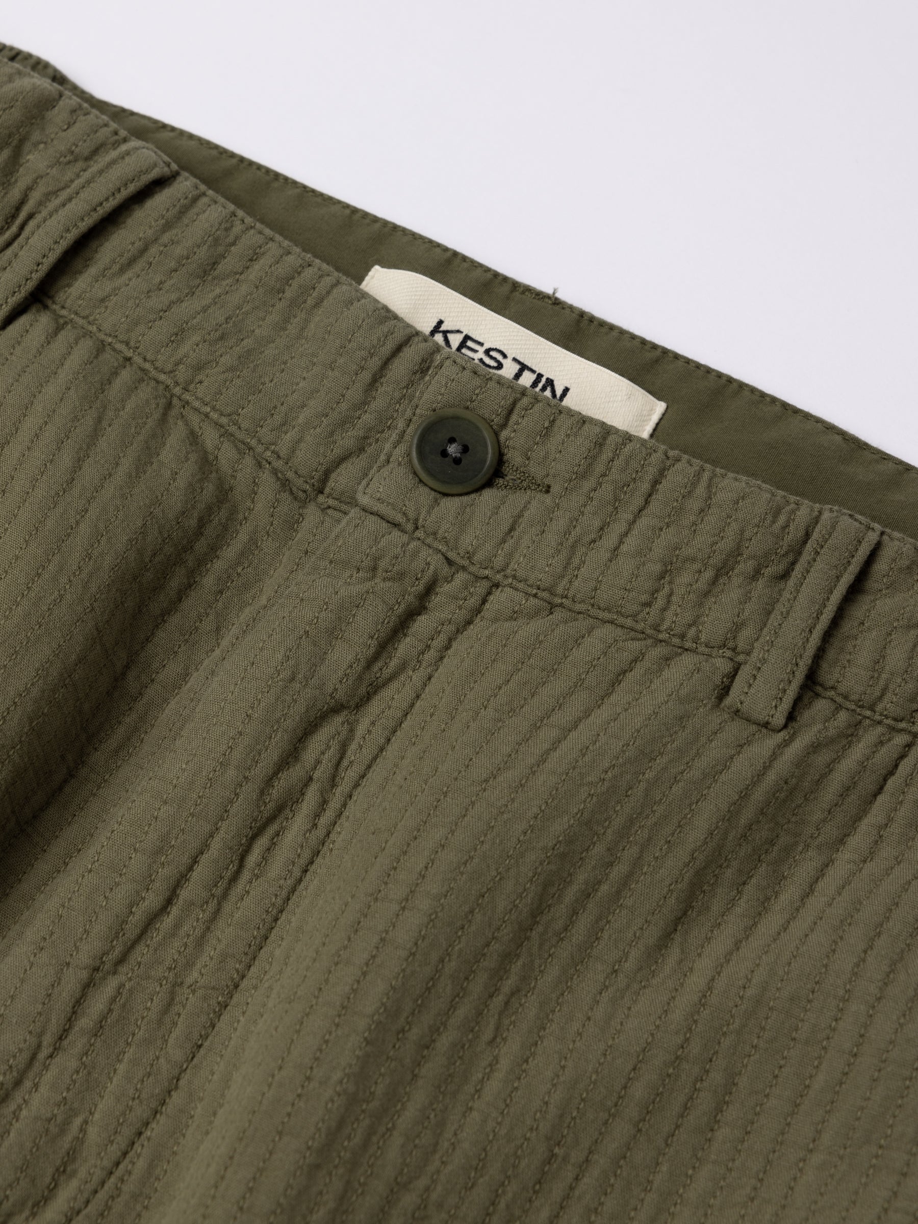The waistband and button to the front of the KESTIN Aberlour Pant in a textured cotton.