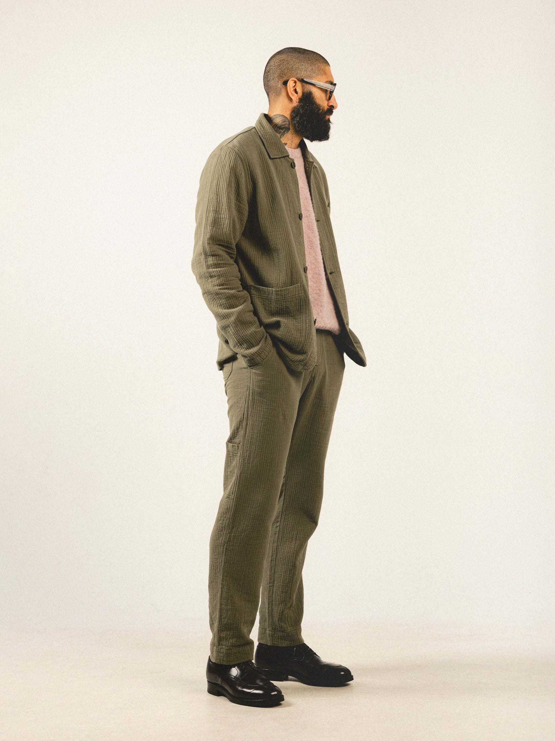 A man wearing a casual olive green suit from Scottish premium menswear brand KESTIN.
