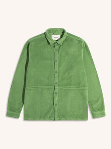 A men's overshirt made from a garment-dyed green corduroy, on a white background.