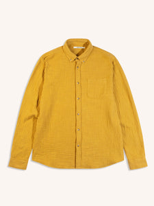 A men's yellow shirt, dyed in a rich yellow colour, on a white background.
