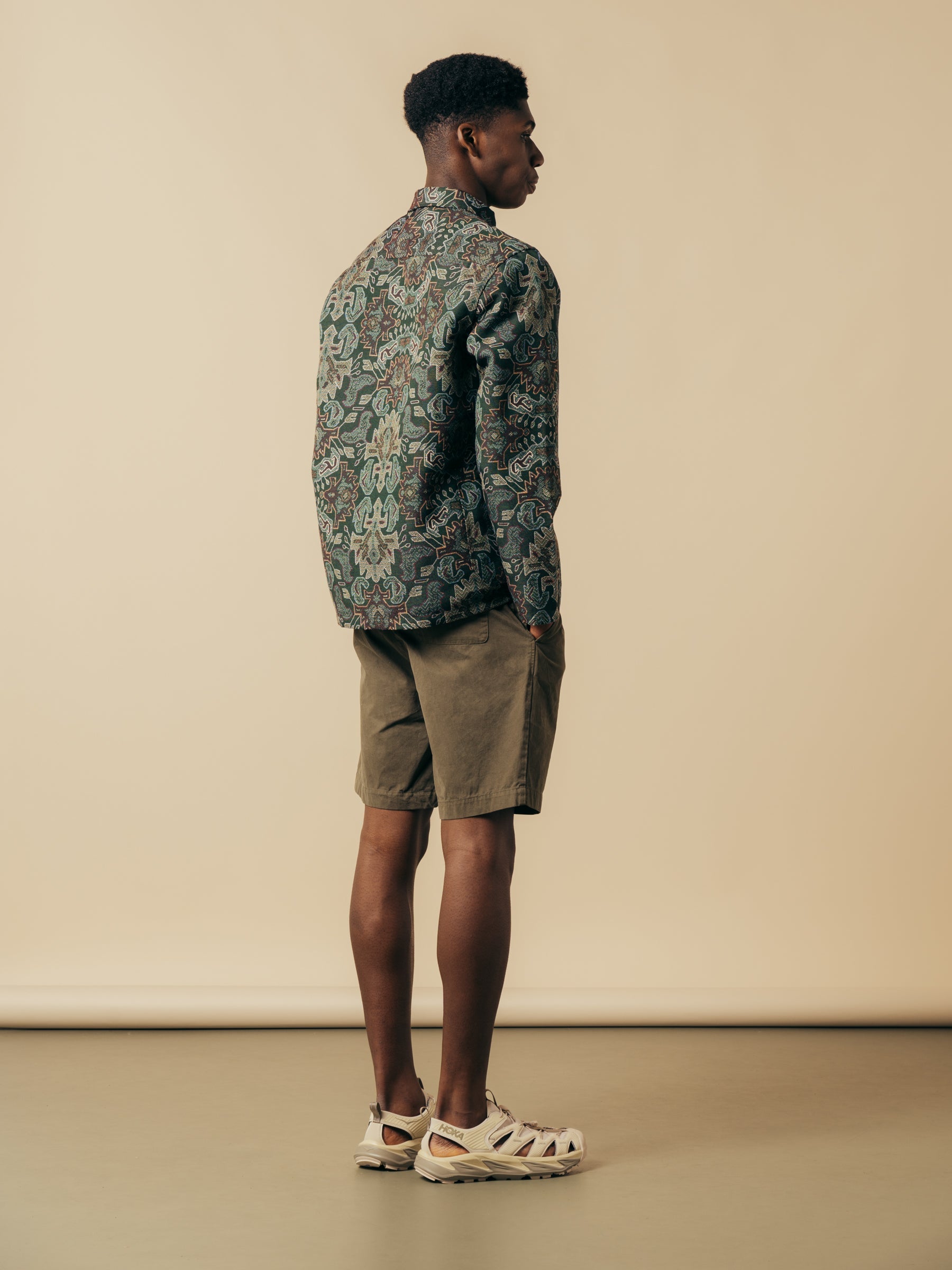 A model showing the back of the KESTIN Inverness Shorts and Ormiston Jacket.