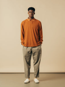 A model wearing a pair of relaxed fit trousers and a polo shirt from KESTIN.