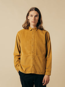A model wearing the KESTIN Armadale Overshirt in tobacco corduroy.