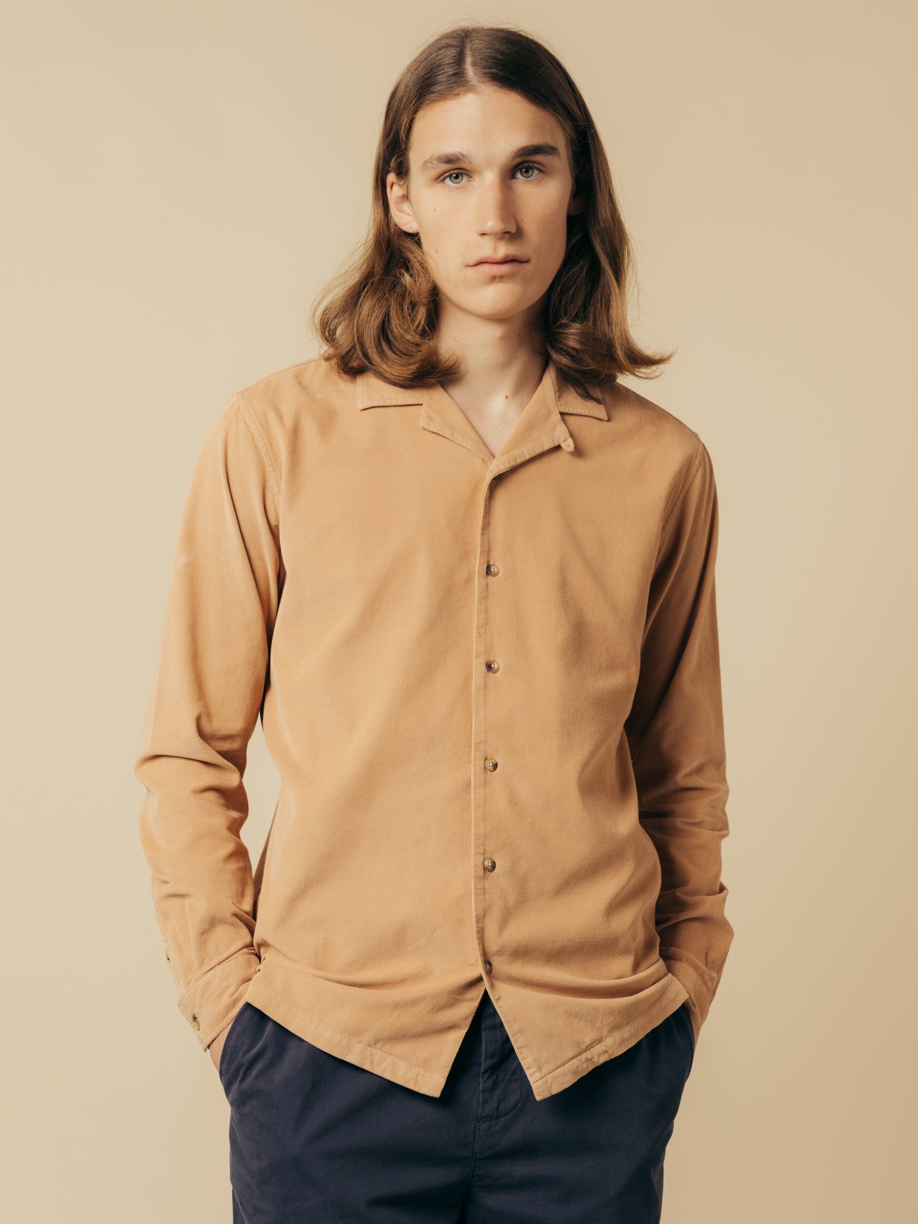 A model wearing the KESTIN Tain Shirt, made from organic cotton corduroy.