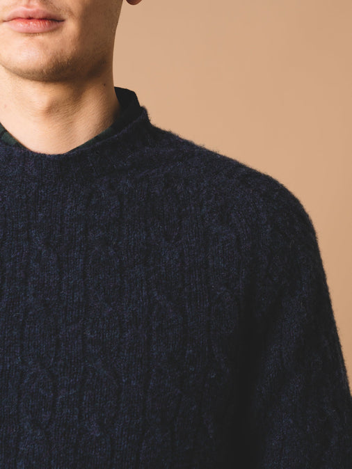 The shoulder of the KESTIN Galloway Cable Knit Sweater in Airforce Blue.