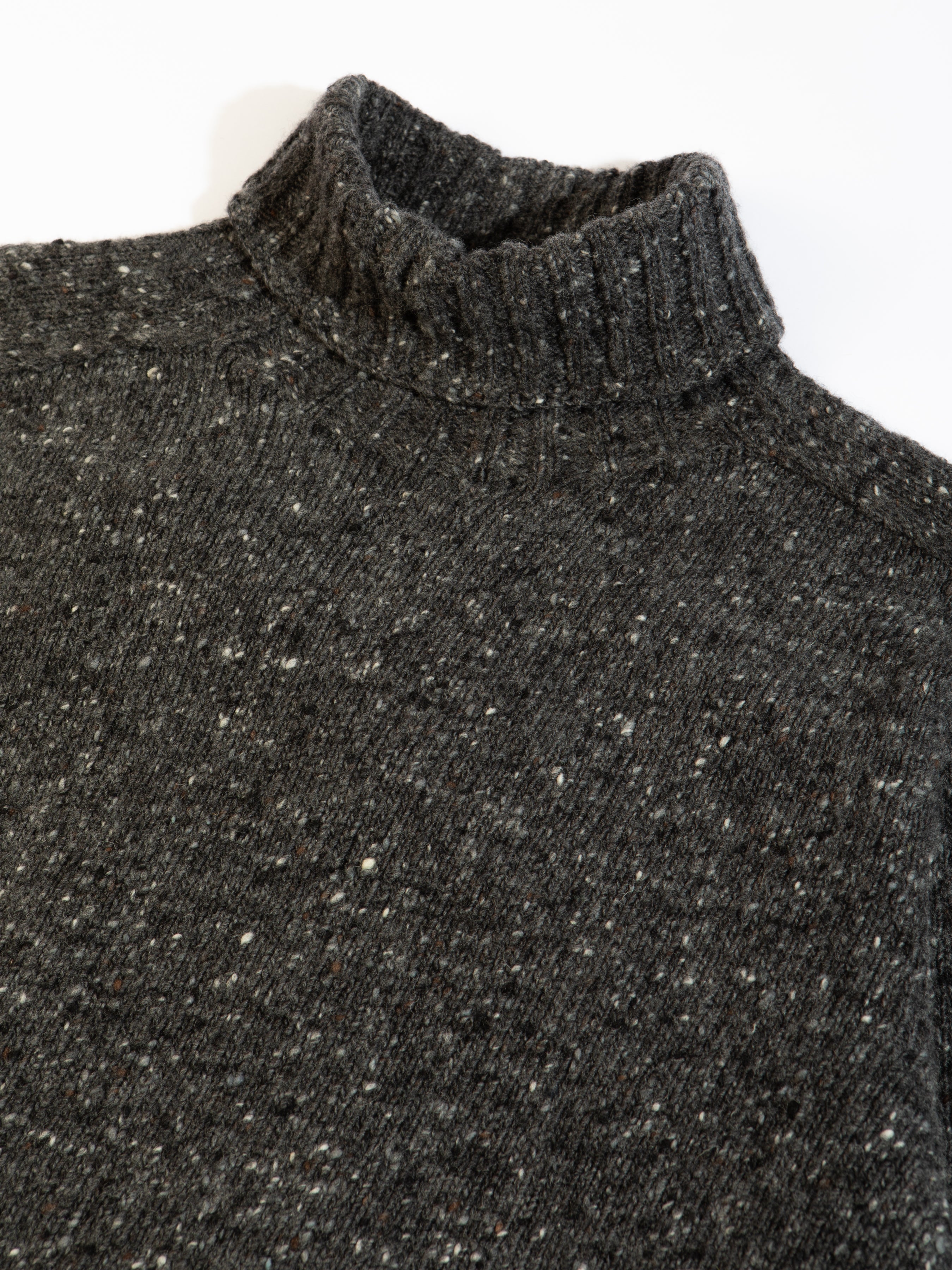 A knitted sweater from KESTIN, made in Scotland from Donegal wool in a charcoal grey.