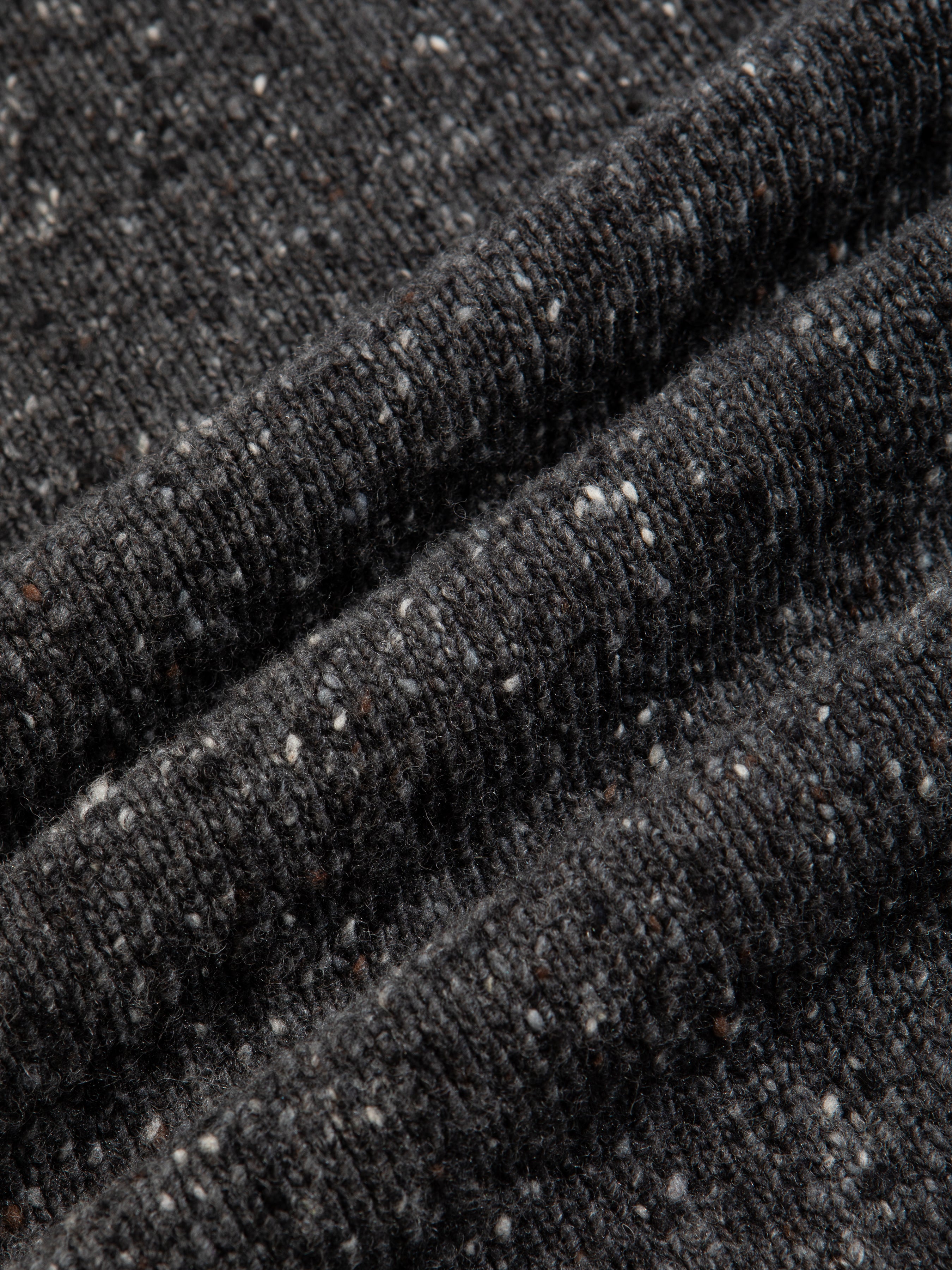 A Donegal wool material, spun in Ireland in a charcoal grey material.