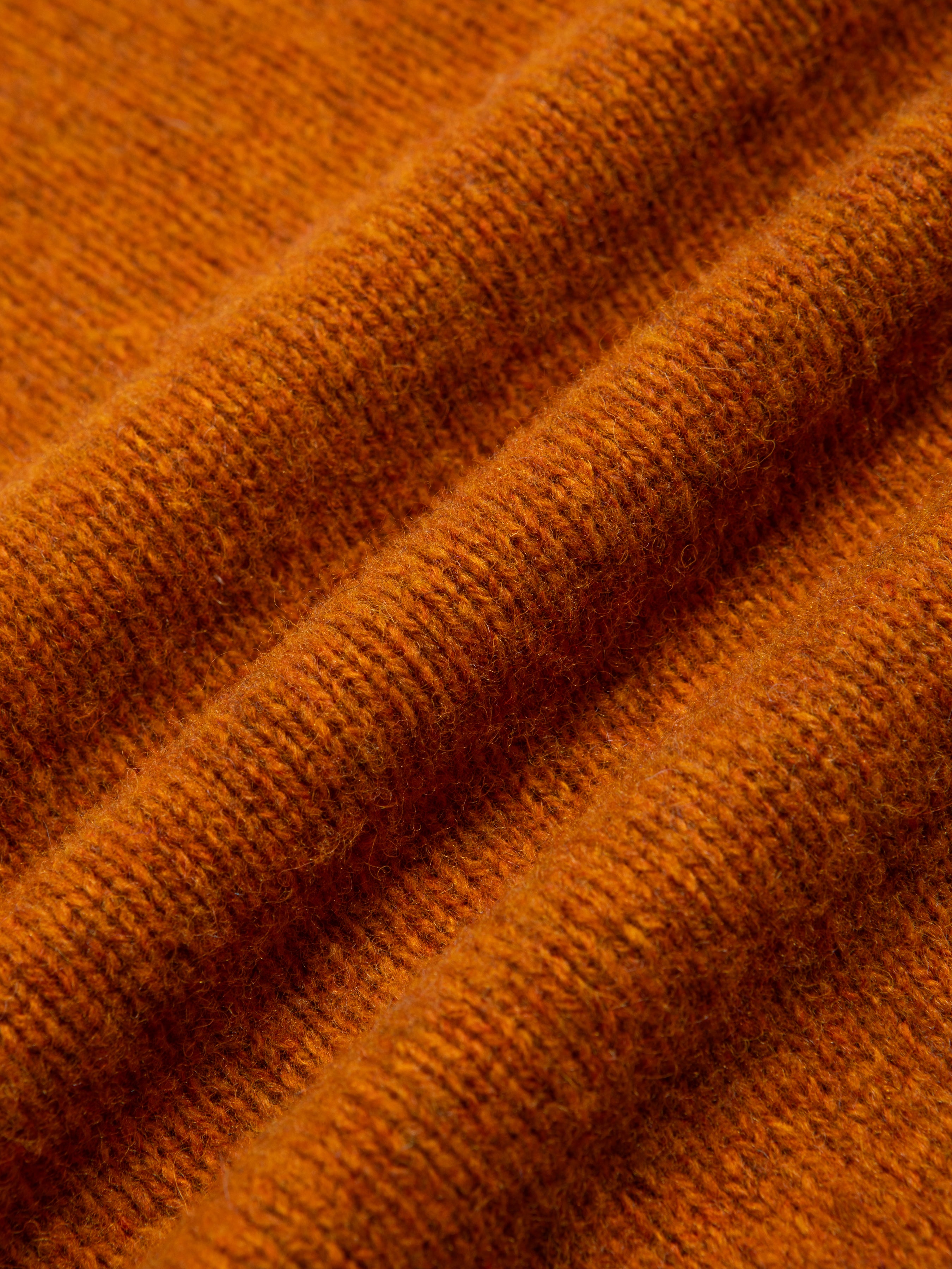 A brushed shetland wool material in a bright orange colour.