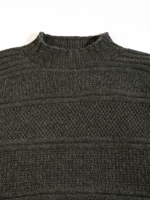 A charcoal grey sweater from menswear brand KESTIN, made in Scotland from merino wool.