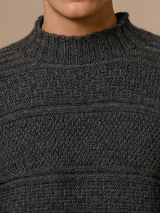 A ribbed mock neck on a men's knitted sweater, made in Scotland.
