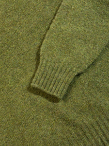 A ribbed cuff and hem on a Shetland wool sweater in green.