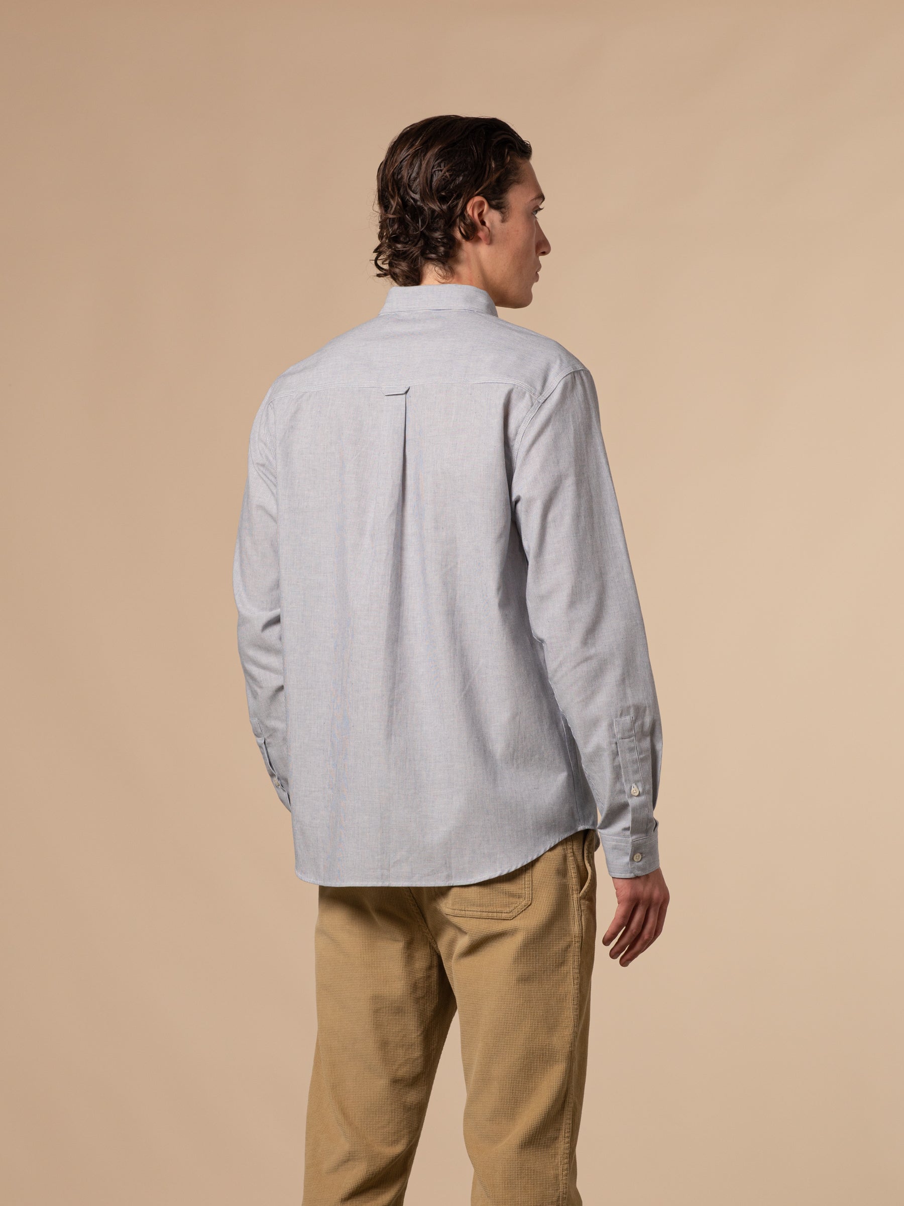 The rear profile of the KESTIN Raeburn Oxford Shirt in a blue and white stripe.