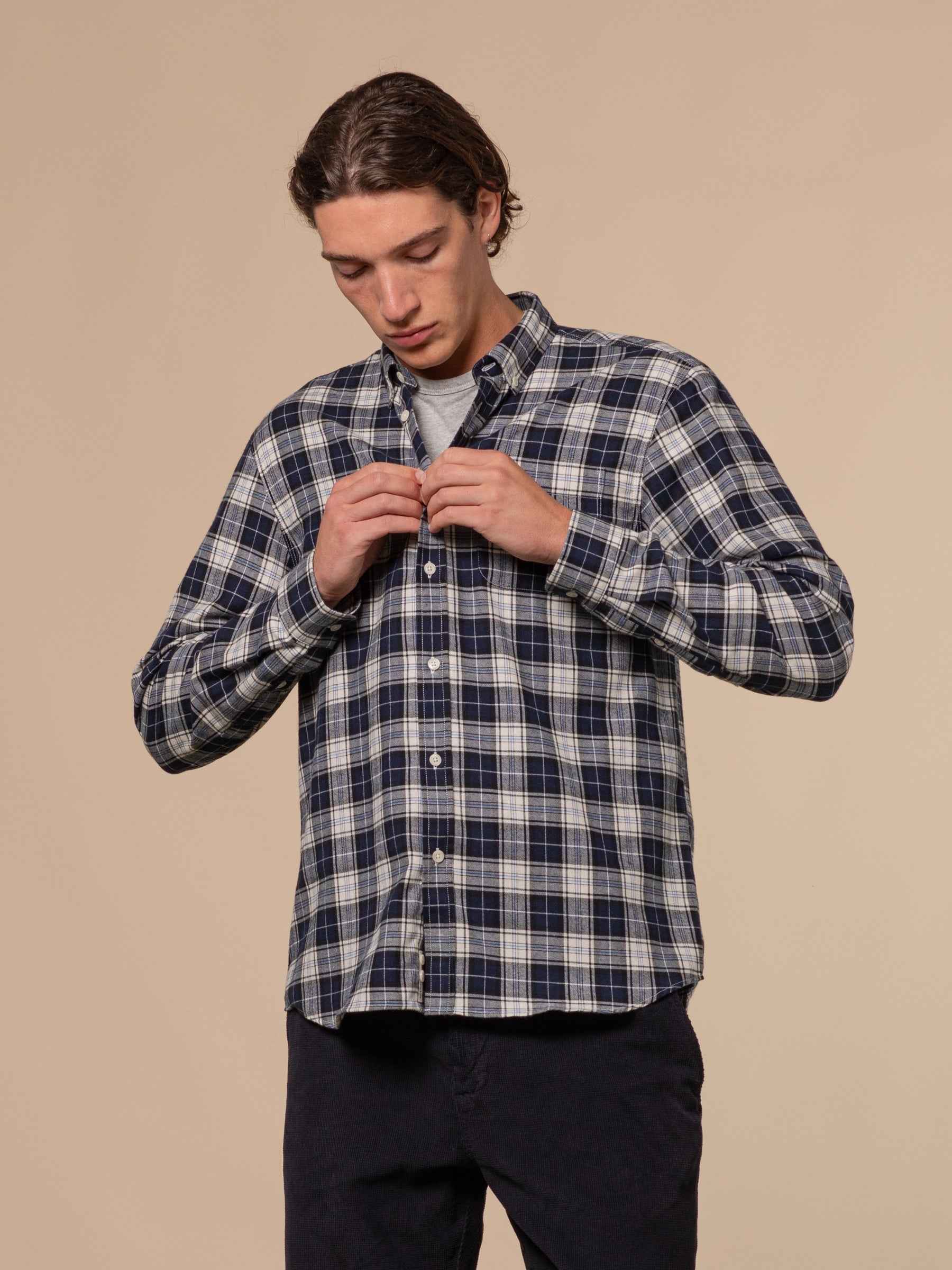 A model buttoning up the KESTIN Raeburn Shirt in Japanese Cotton.
