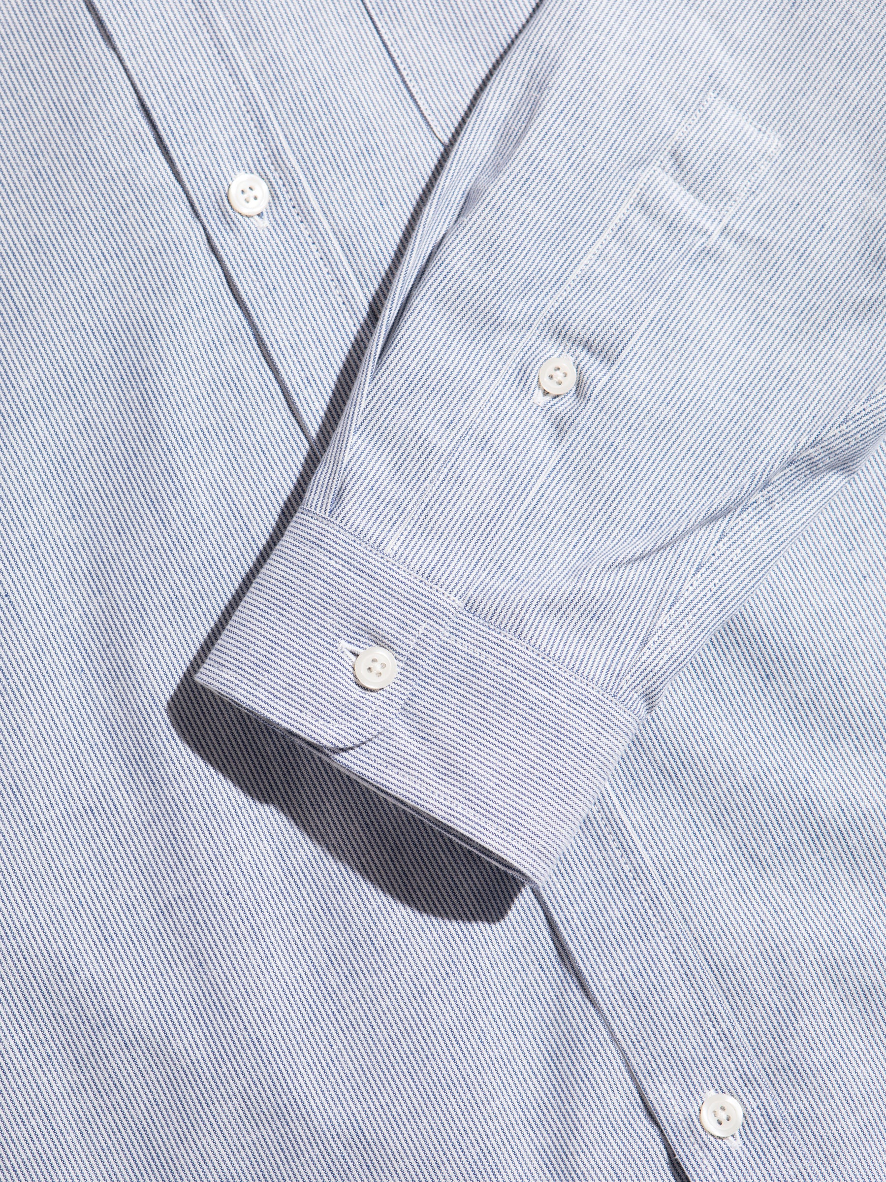 The buttoned front and cuff from the KESTIN Raeburn Shirt in Thin Blue Stripe