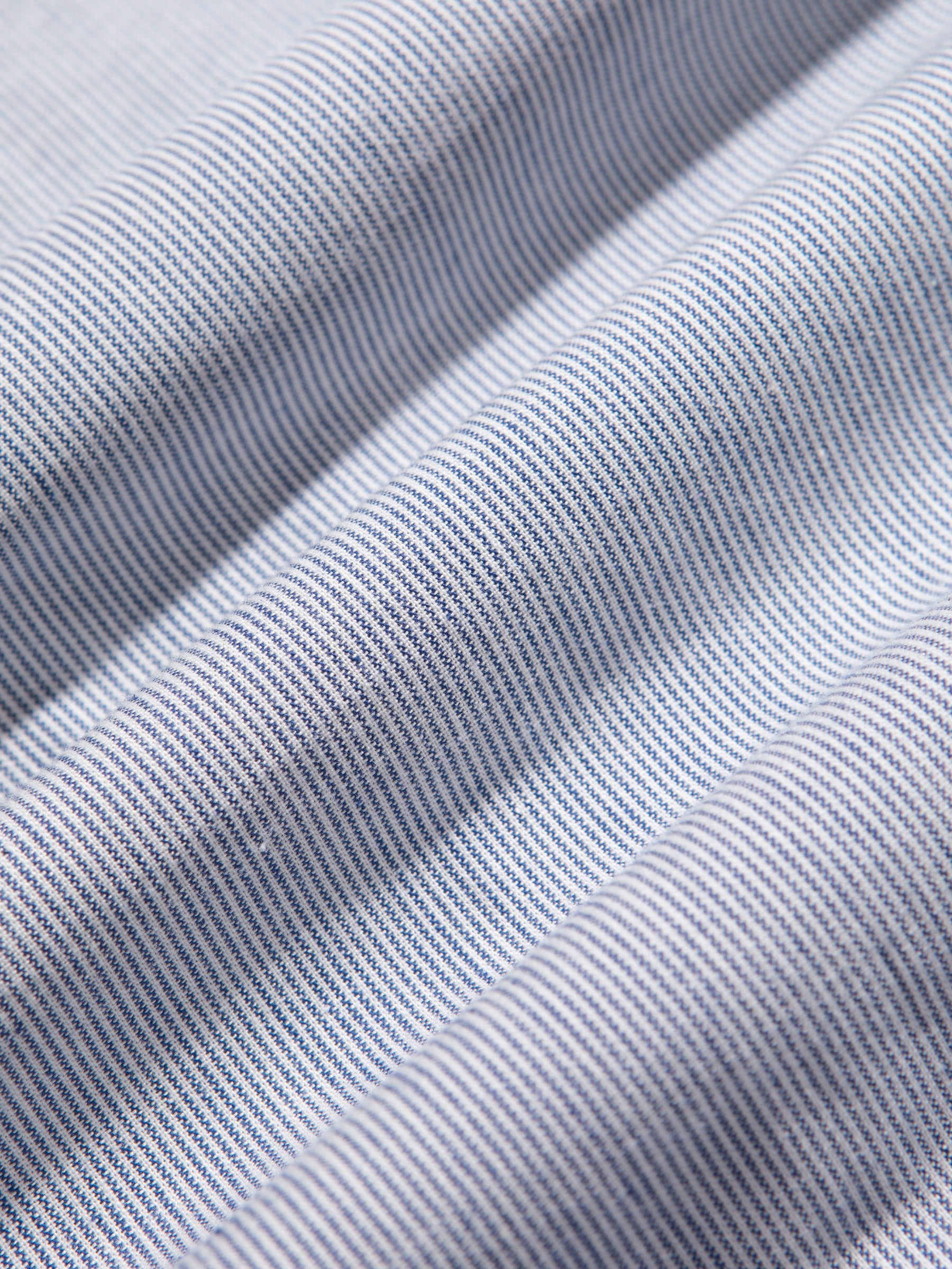 A white and blue striped fabric from the Raeburn Shirt by menswear brand KESTIN.
