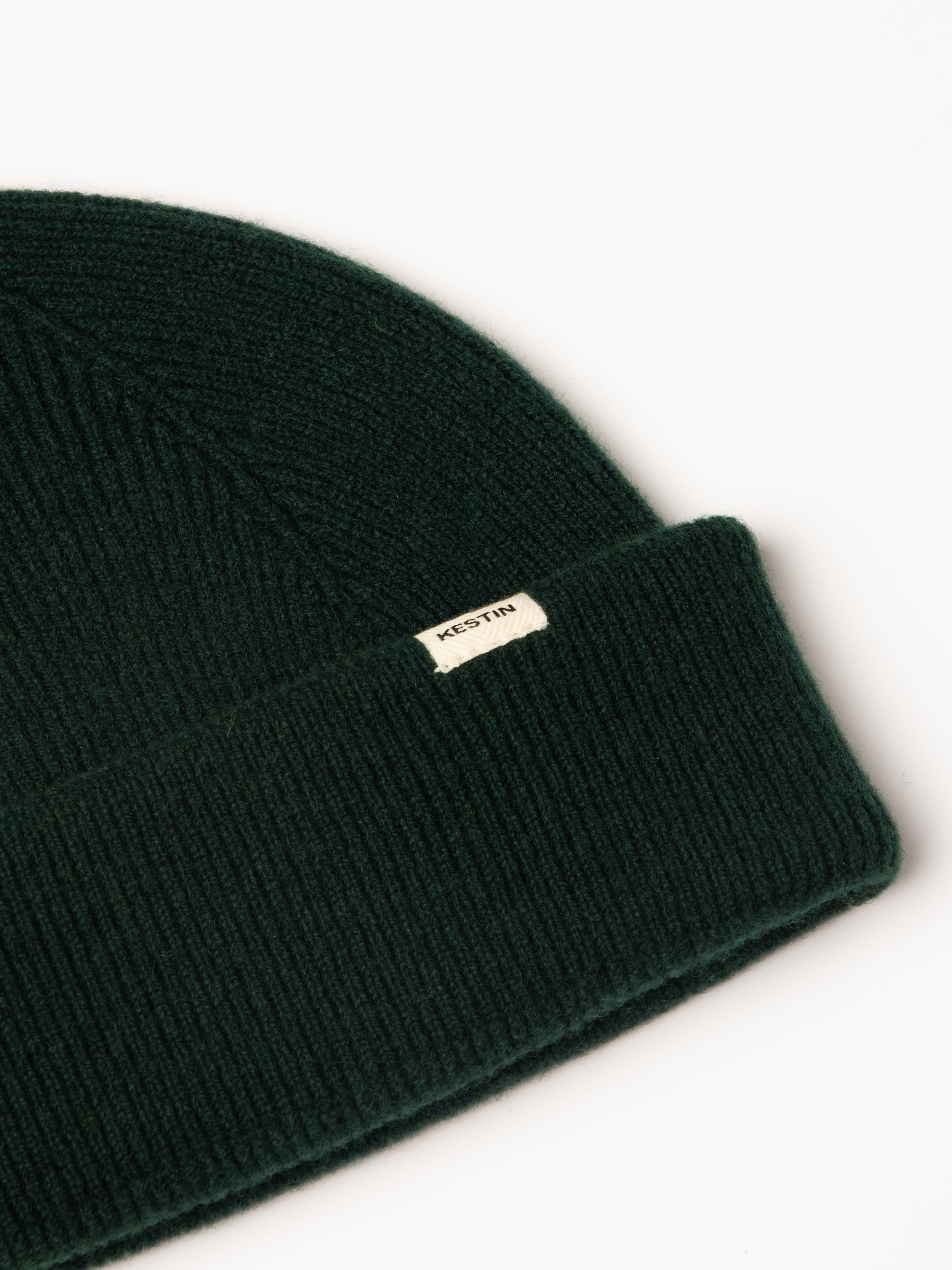 A woven logo tag to the cuff of the KESTIN Braemar Beanie.