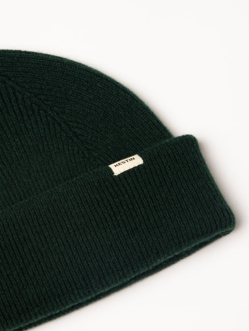 A woven logo tag to the cuff of the KESTIN Braemar Beanie.