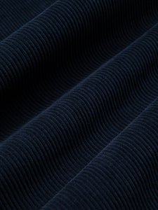 A close-up of a dark navy blue corduroy fabric.