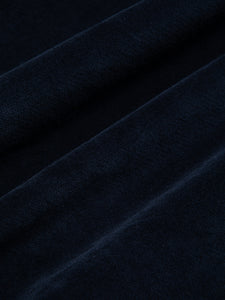 A close-up of a dark navy blue moleskin fabric, used by KESTIN.