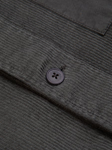The button to the front of an overshirt from menswear designer KESTIN