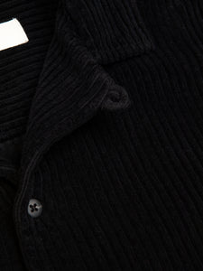 A loop detail used to fully button the Tain Overshirt's collar.