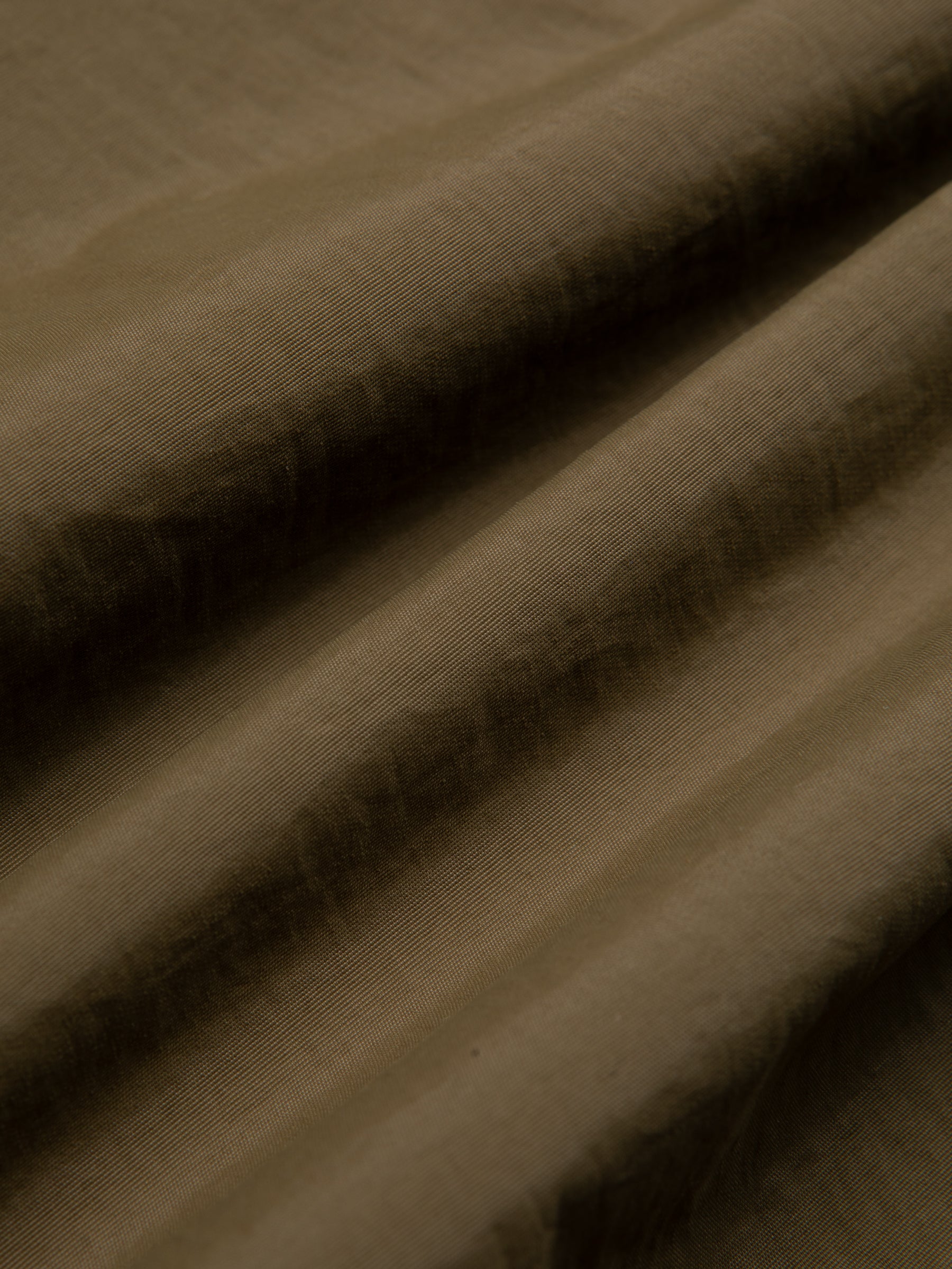 A green Italian wool fabric used by menswear brand KESTIN to make a winter jacket.