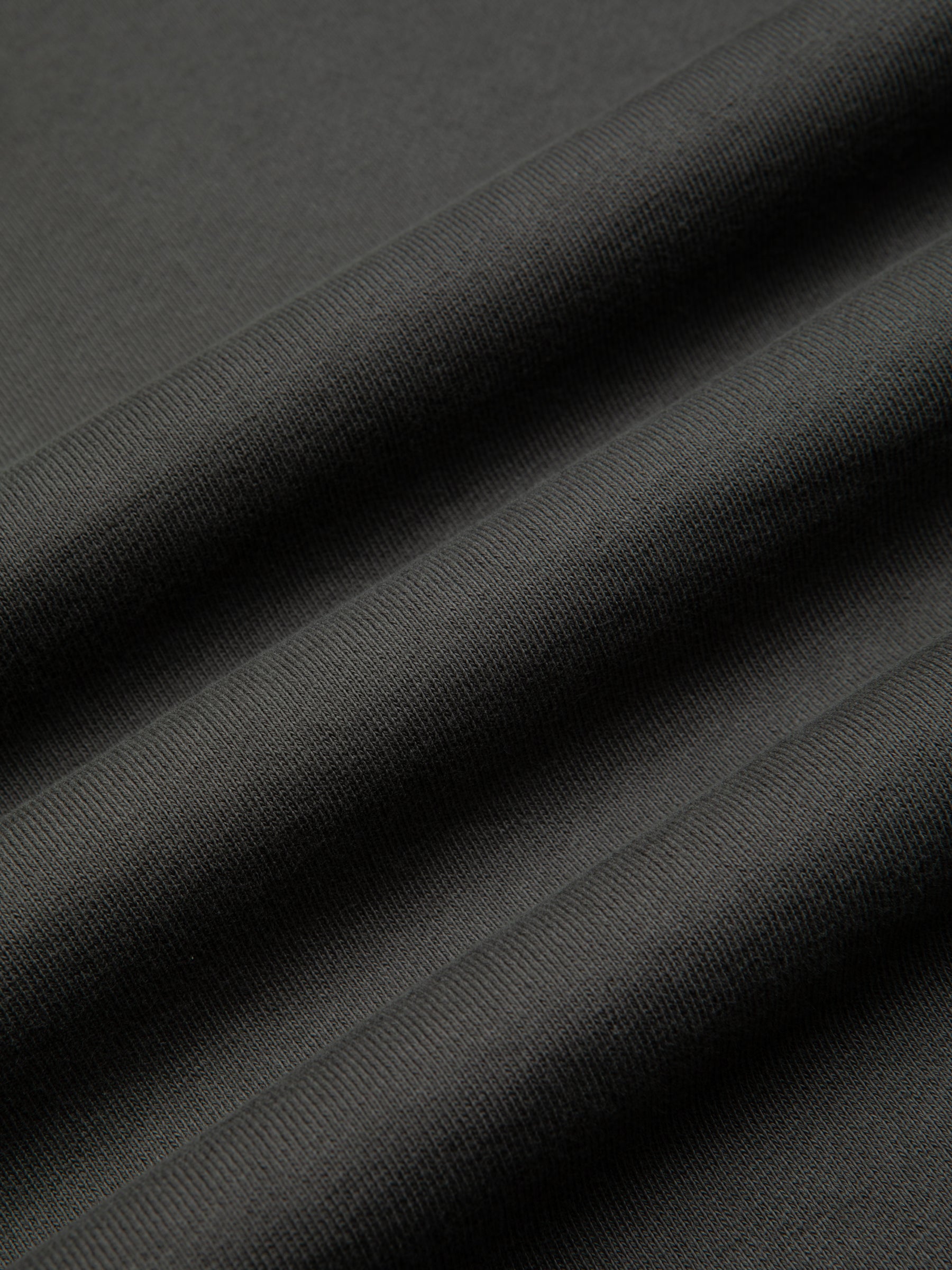 A grey garment dyed material used to make sweatshirts by menswear brand KESTIN.