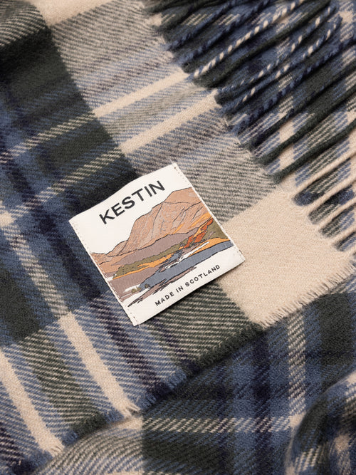Plaid fabric with a Kestin label featuring a scenic design.