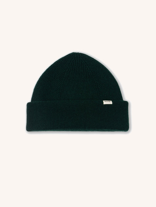 A dark green men's beanie on a white background.