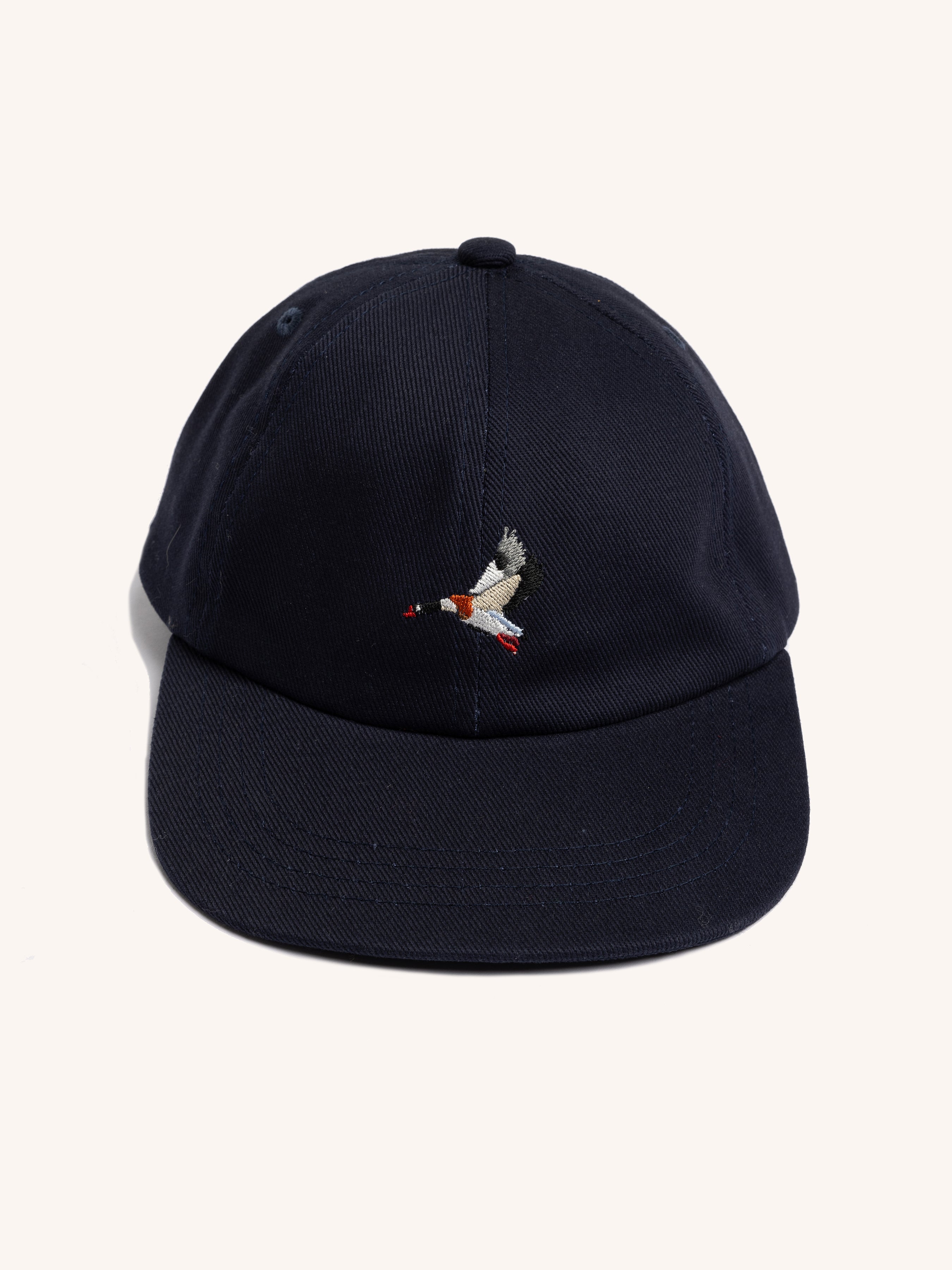 Navy blue cap with a small embroidered duck design on a white background