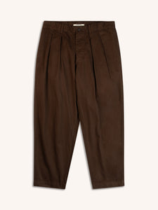A pair of dark brown trousers with a loose tapered fit, on a white background.
