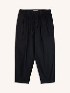 A pair of navy blue trousers with a loose tapered fit, on a white background.