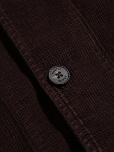 A branded button from menswear designer KESTIN, sewn to the Huntly Jacket.