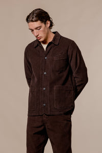 A man wearing a smart chore coat, designed by premium menswear brand KESTIN.