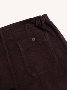 A rear pocket on a pair of dark brown corduroy trousers by KESTIN.