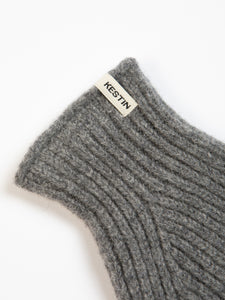 A woven KESTIN logo tag to the cuff of a brushed lambswool glove.