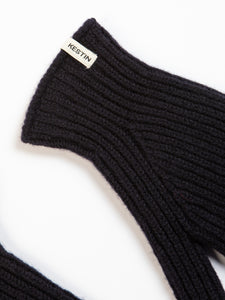 The cuff of a brushed lambswool glove in navy blue, on a white background. 