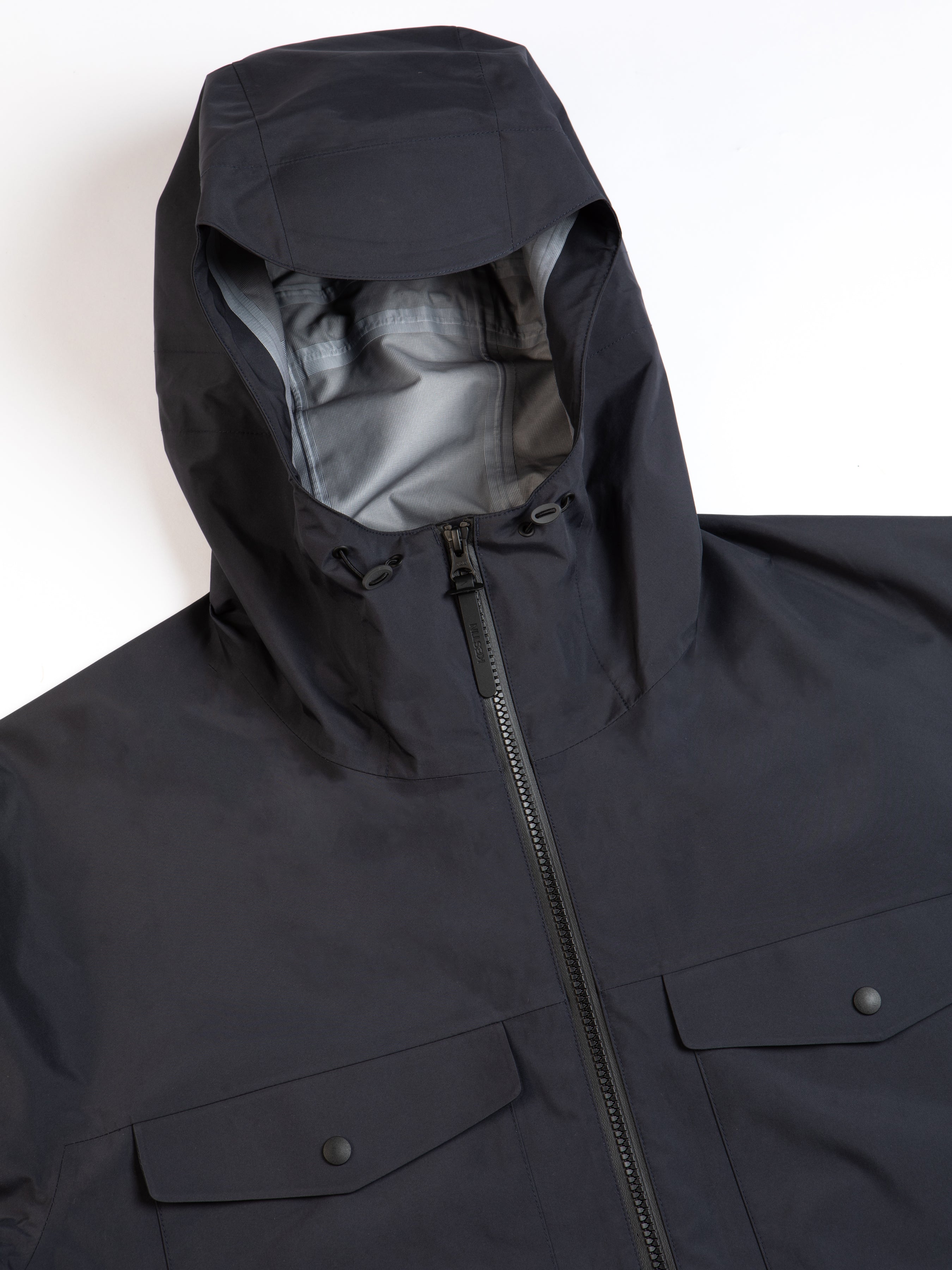 The hood of a technical waterproof shell jacket on a white background.