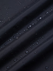 Water beading on a technical waterproof shell jacket in navy blue.