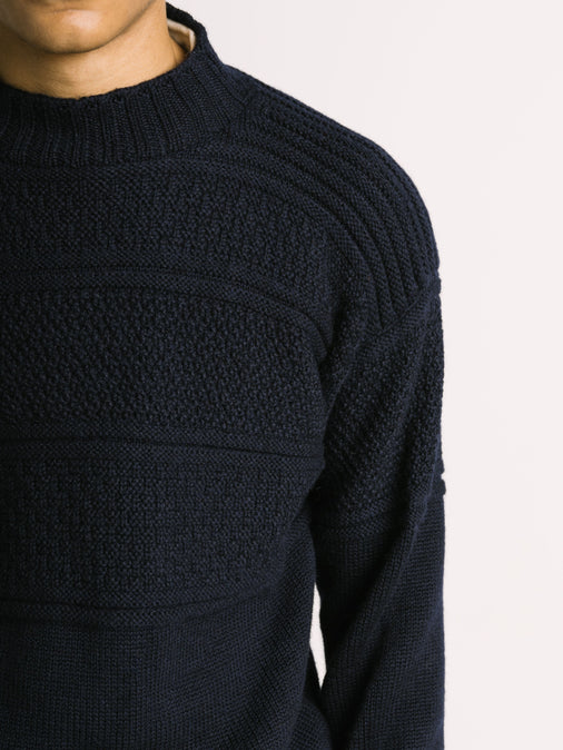 The shoulder fit of a knitted merino wool sweater, made in Scotland by menswear designer KESTIN.