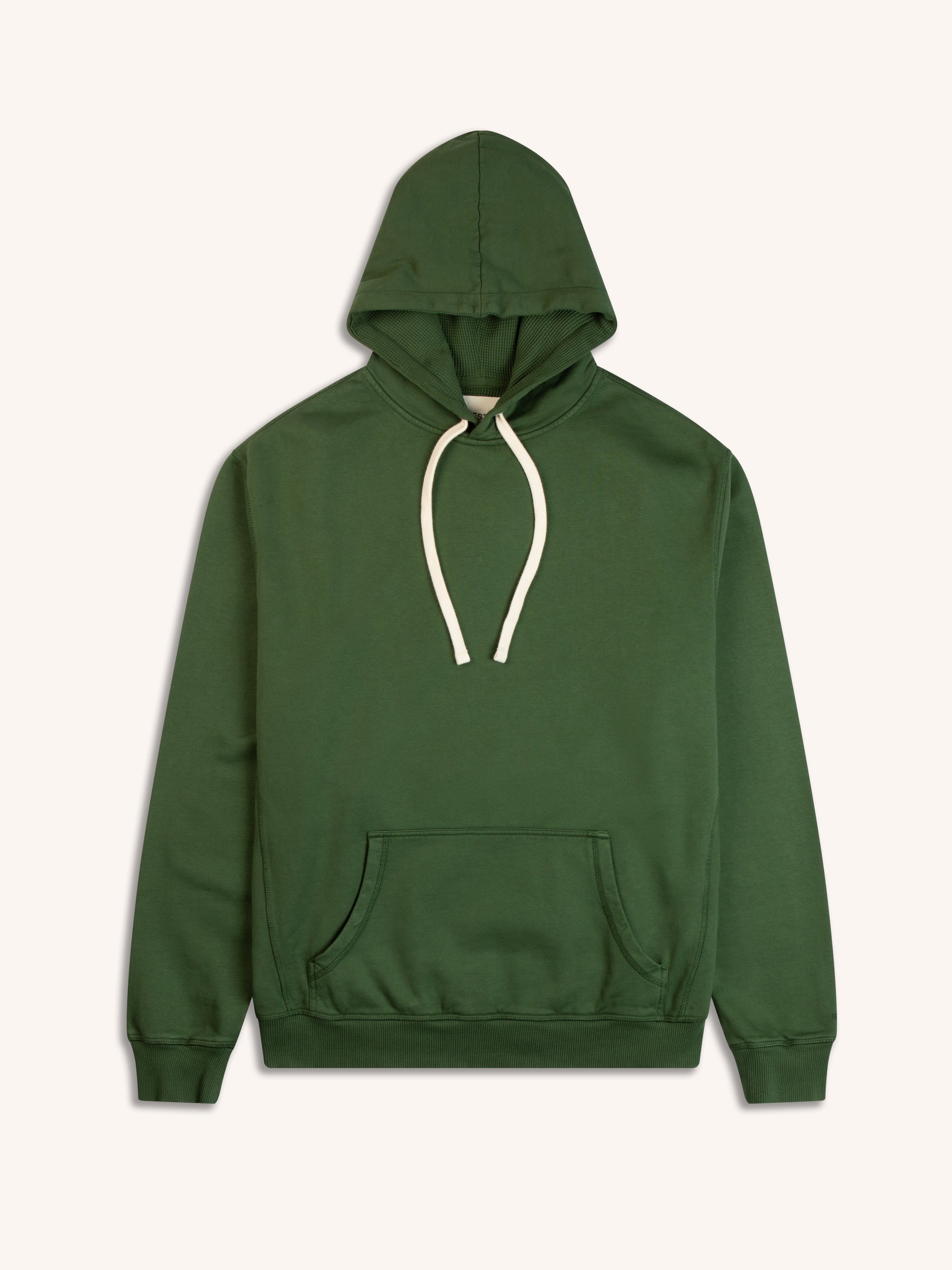 A pullover hoodie from Scottish menswear brand KESTIN, garment dyed in green, on a white background.